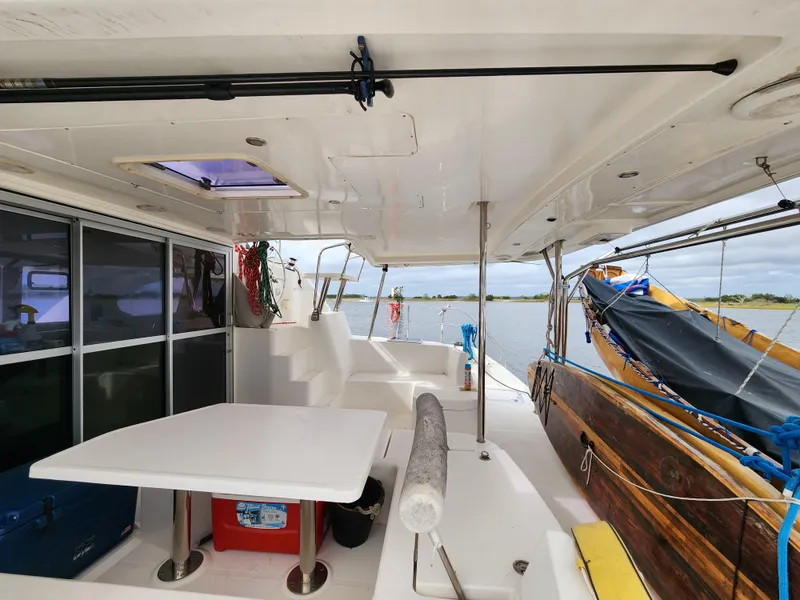 Slide: The Image of Spacious 2015 Leopard 44 catamaran cockpit with seating, table, and helm station. - 9