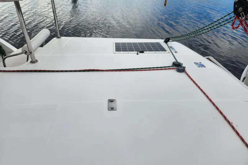 Slide: The Image of Deck of 2015 Leopard 44 catamaran with solar panel and ropes on calm water. - 90