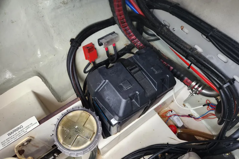 Slide: The Image of Battery compartment of a 2015 Leopard 44 boat with wiring and components. - 96
