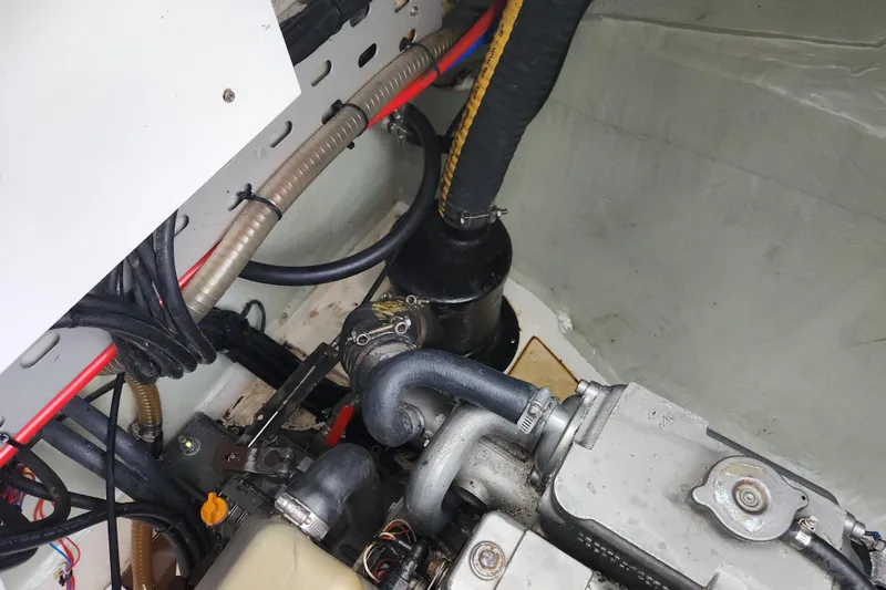 Slide: The Image of Engine compartment of a 2015 Leopard 44 yacht, showing hoses and mechanical components. - 99