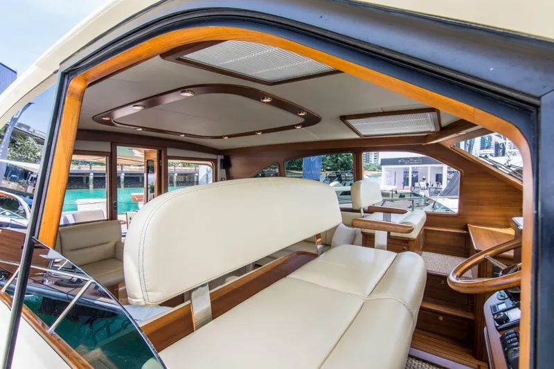 Slide: The Image of Luxurious interior of 2026 Palm Beach Motor Yachts PB52, featuring elegant seating and wood accents. - 16