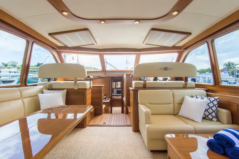 Slide: The Image of Luxurious interior of 2026 Palm Beach Motor Yachts PB52, featuring elegant seating and wood finishes. - 2