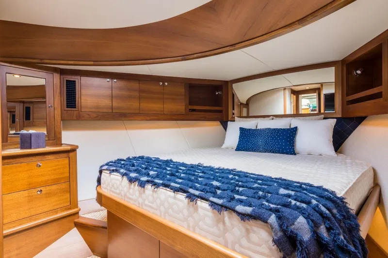 Slide: The Image of Luxurious bedroom interior of 2026 Palm Beach Motor Yachts PB52, featuring elegant wood finishes. - 4