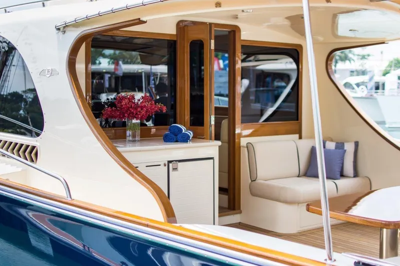 Slide: The Image of 2026 Palm Beach Motor Yachts PB52 interior with elegant seating and floral arrangement. - 6