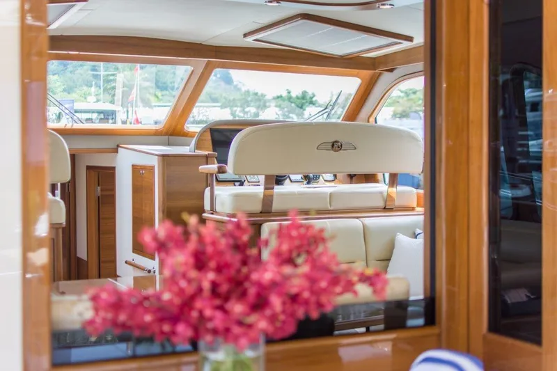 Slide: The Image of Luxurious interior of 2026 Palm Beach Motor Yachts PB52 with elegant seating and floral decor. - 12