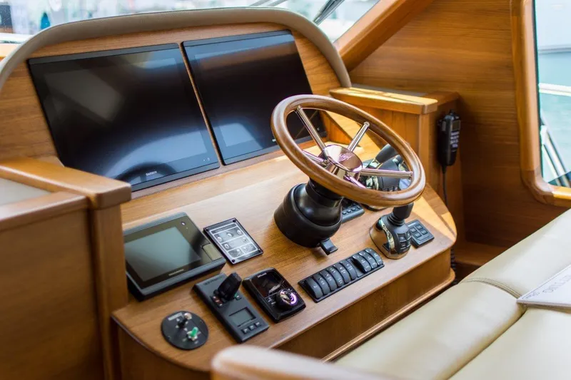 Slide: The Image of Helm of 2026 Palm Beach Motor Yachts PB52, featuring modern navigation controls and wooden finish. - 15