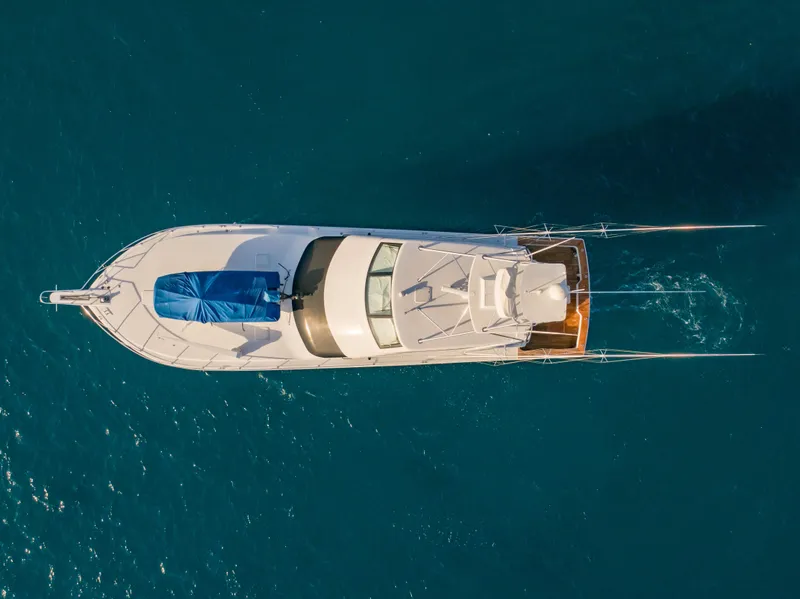 Slide: The Image of Aerial view of 2003 Viking 65 Convertible Enclosed Bridge yacht on blue water. - 10