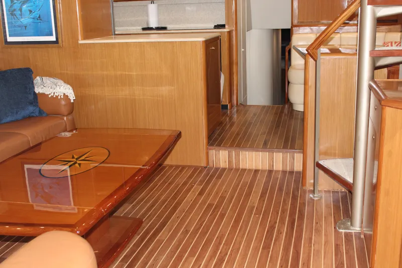 Slide: The Image of Interior of 2003 Viking 65 Convertible Enclosed Bridge with wooden flooring and modern furnishings. - 13