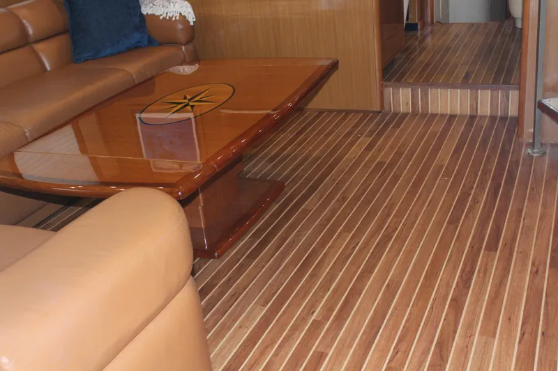 Slide: The Image of Luxurious interior of 2003 Viking 65 Convertible Enclosed Bridge with wooden flooring and leather seating. - 16