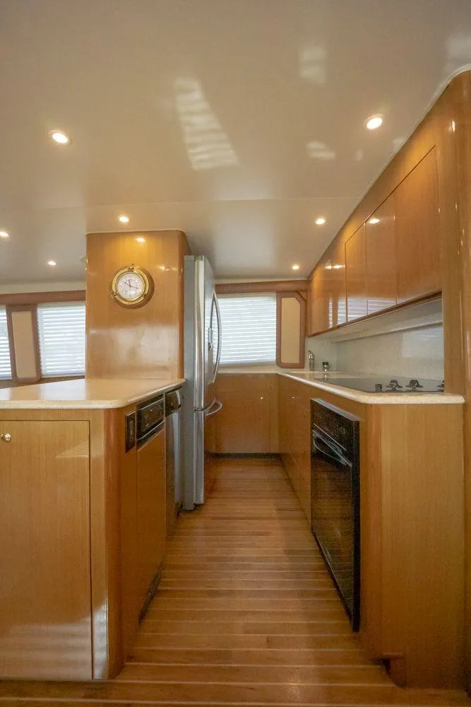 Slide: The Image of Luxurious kitchen interior of 2003 Viking 65 Convertible Enclosed Bridge yacht. - 21
