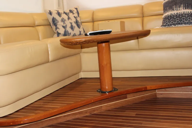 Slide: The Image of Luxurious interior of 2003 Viking 65 Convertible yacht with leather seating and wooden table. - 24