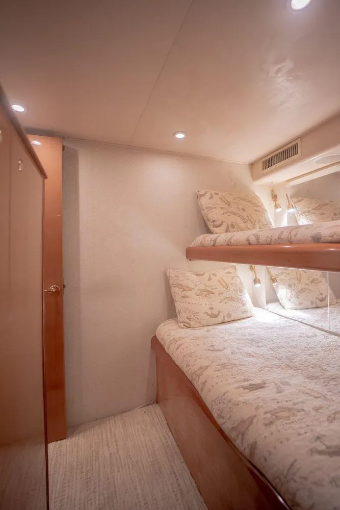Slide: The Image of Interior of 2003 Viking 65 Convertible Enclosed Bridge with cozy bunk beds. - 36