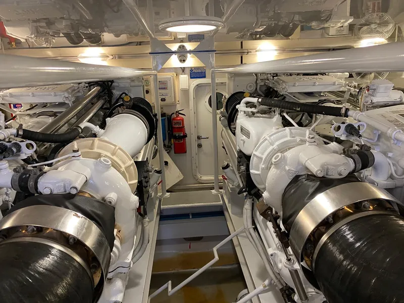 Slide: The Image of Engine room of a 2003 Viking 65 Convertible Enclosed Bridge yacht, showcasing dual engines. - 38