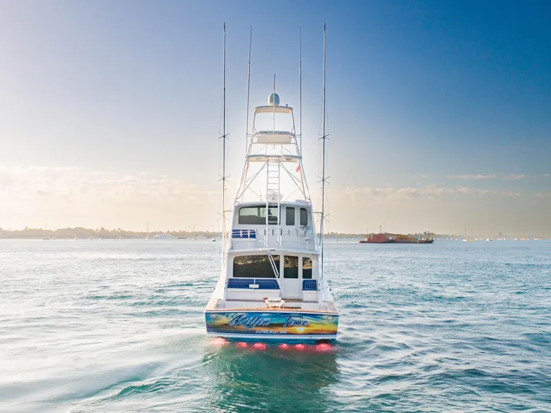 Slide: The Image of 2003 Viking 65 Convertible Enclosed Bridge yacht on open water, rear view. - 8