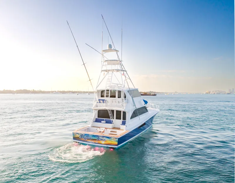 Slide: The Image of 2003 Viking 65 Convertible Enclosed Bridge yacht cruising on open water. - 9