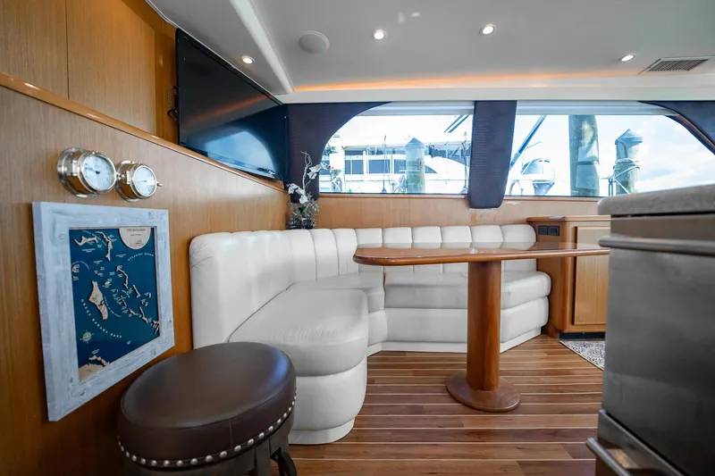 Slide: The Image of Luxurious interior of 2000 Viking 50 Conv Sport Fisher yacht with white seating and wood accents. - 19