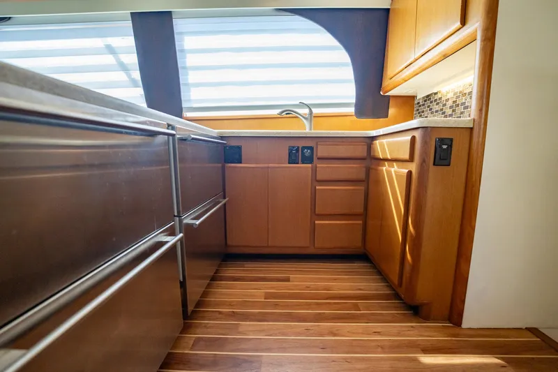 Slide: The Image of Interior of 2000 Viking 50 Conv Sport Fisher kitchen with wood cabinets and flooring. - 20