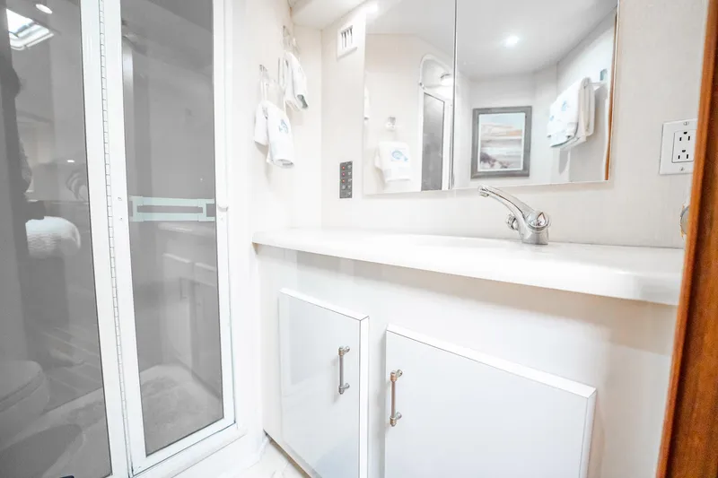 Slide: The Image of Bathroom interior of 2000 Viking 50 Conv Sport Fisher yacht, featuring modern fixtures. - 27