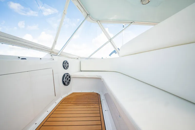 Slide: The Image of Luxurious interior of 2000 Viking 50 Conv Sport Fisher with white seating and wooden flooring. - 38