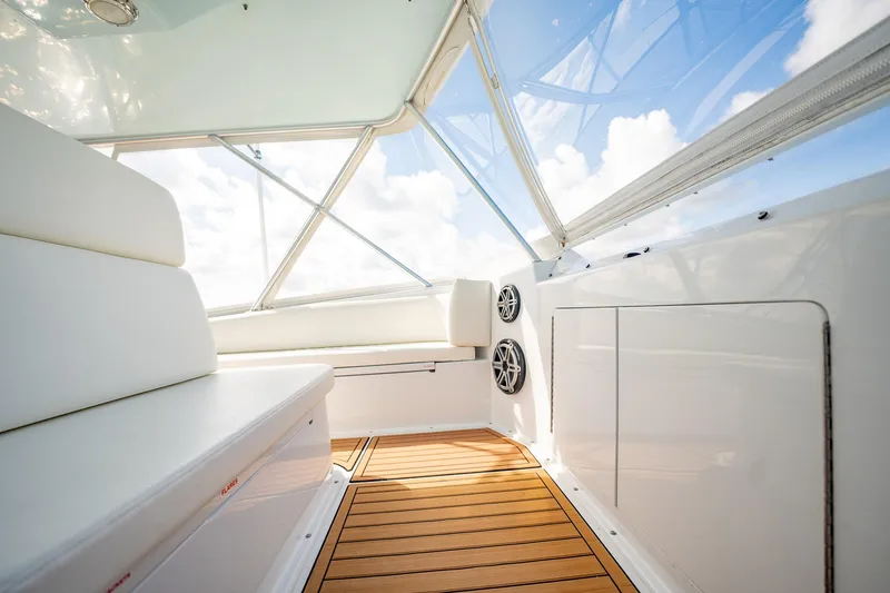 Slide: The Image of Interior of 2000 Viking 50 Conv Sport Fisher with white seating and wooden flooring. - 39