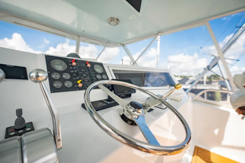 Slide: The Image of Steering wheel and controls of 2000 Viking 50 Conv Sport Fisher boat. - 42
