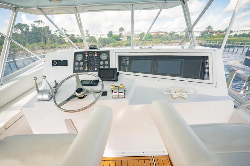 Slide: The Image of Cockpit of 2000 Viking 50 Conv Sport Fisher with steering wheel and navigation controls. - 45