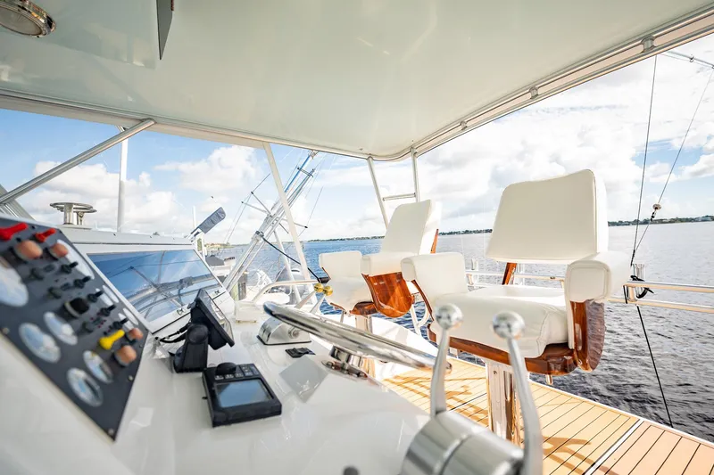Slide: The Image of Viking 50 Conv Sport Fisher 2000 yacht helm with controls and seating, overlooking the ocean. - 48