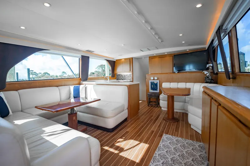 Slide: The Image of Luxurious interior of 2000 Viking 50 Conv Sport Fisher yacht with white seating and wood accents. - 6