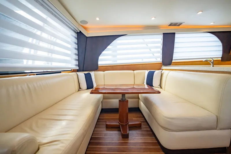 Slide: The Image of Luxurious interior of 2000 Viking 50 Conv Sport Fisher yacht with plush seating and wooden table. - 8