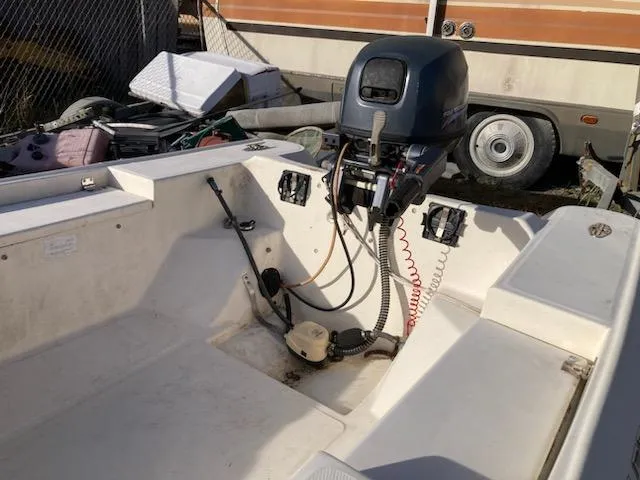 Slide: The Image of 1998 Jouet 13 boat interior with outboard motor and control panel. - 4