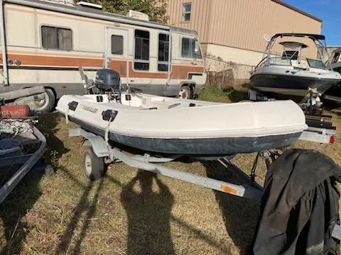 Slide: The Image of Inflatable boat on trailer beside RV and other boats, Jouet 13 model, 1998. - 5