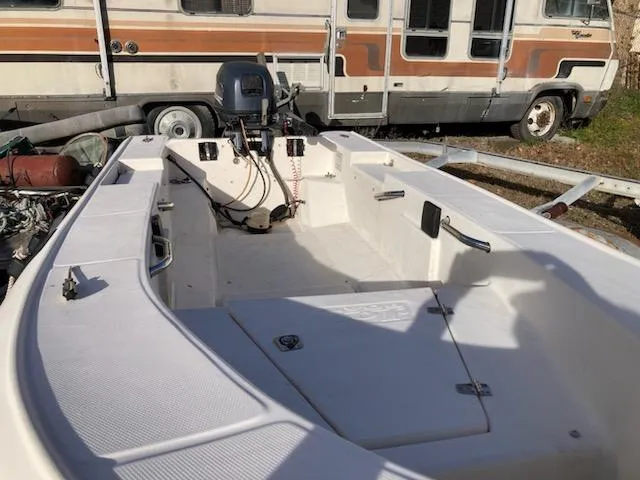 Slide: The Image of Open deck of a 1998 Jouet 13 boat, parked near an RV. - 6