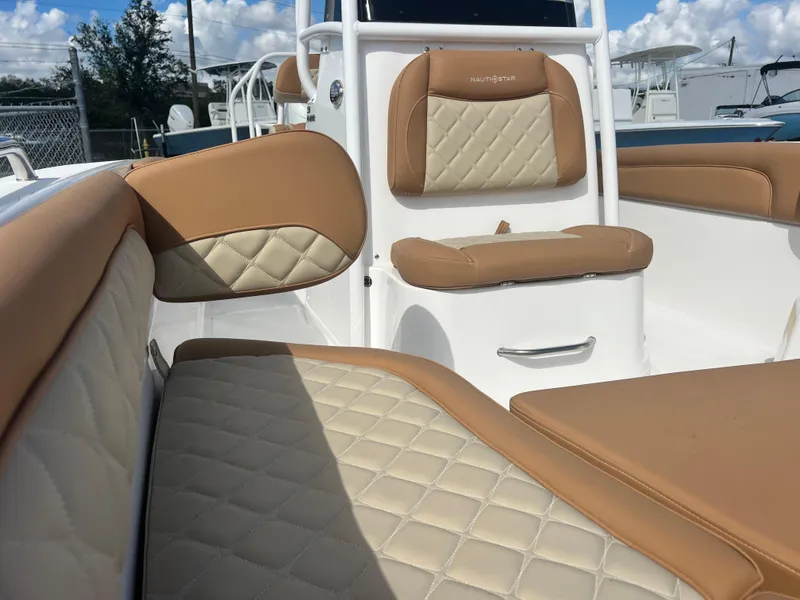 Slide: The Image of 2025 NauticStar 231 Hybrid boat interior with tan and cream quilted seating. - 6