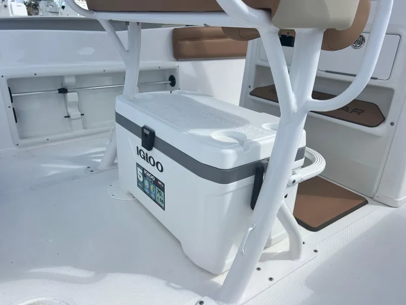 Slide: The Image of 2025 NauticStar 231 Hybrid boat interior with Igloo cooler under seat. - 7