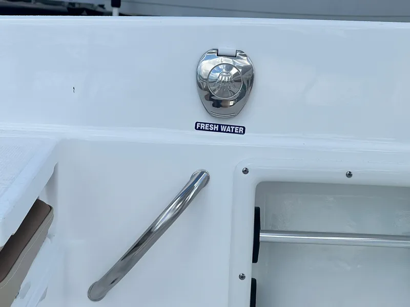 Slide: The Image of 2025 NauticStar 231 Hybrid boat fresh water access with chrome handle. - 8