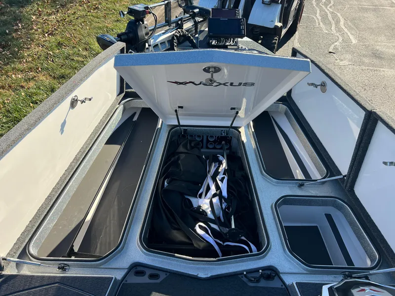 Slide: The Image of 2024 Vexus VXS20 boat storage compartments with open hatch, showcasing interior space. - 21