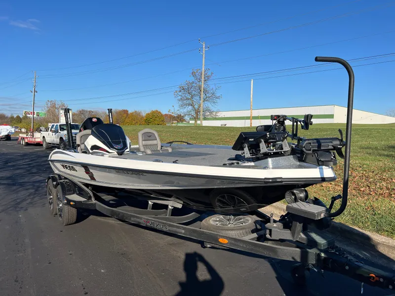Slide: The Image of 2024 Vexus VXS20 boat on trailer, parked on roadside under clear blue sky. - 8