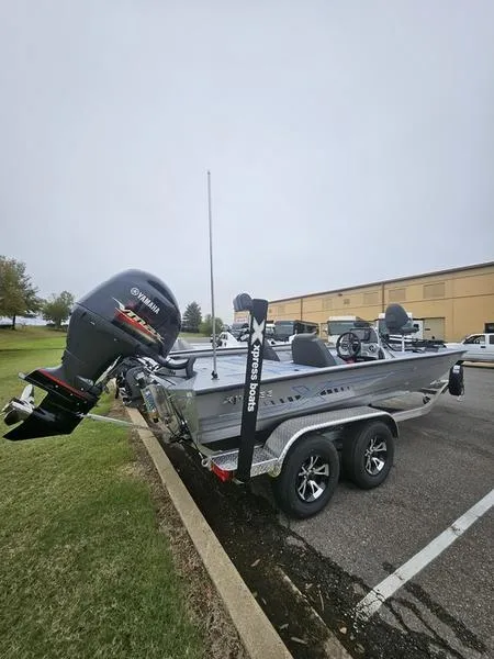 The Image of 2025 Xpress H20 Bass boat in showroom, sleek design on trailer. - 0