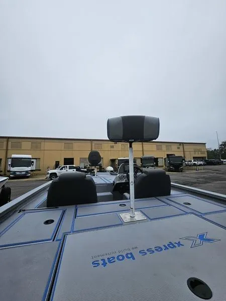 Slide: The Image of Trailer hitch of 2025 Xpress H20 Bass boat on a concrete floor. - 2