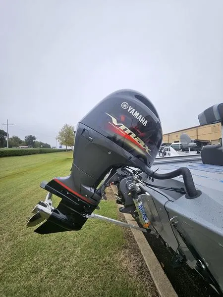 Slide: The Image of 2025 Xpress H20 Bass boat storage compartments with open lids, showcasing interior space. - 9