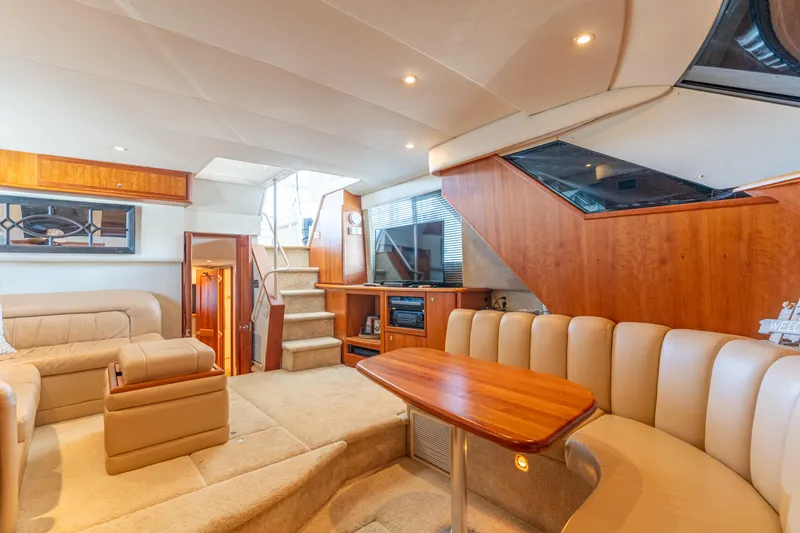 Slide: The Image of Luxurious interior of 2001 Silverton 392 Motor Yacht with plush seating and wood accents. - 19