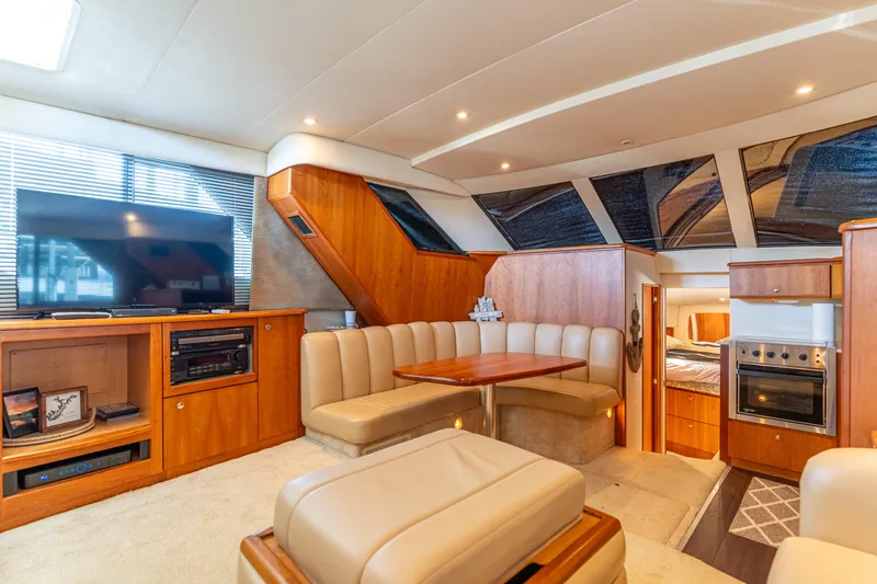 Slide: The Image of Luxurious interior of 2001 Silverton 392 Motor Yacht with plush seating and entertainment area. - 20