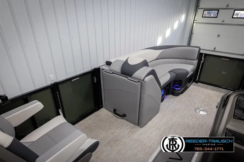 Slide: The Image of 2025 Avalon LSZ QLS pontoon boat interior with gray seating and carpeted flooring. - 21
