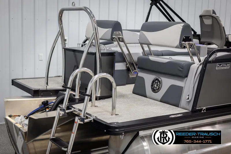 Slide: The Image of 2025 Avalon LSZ QLS pontoon boat with sleek seating and ladder, showcased indoors. - 42