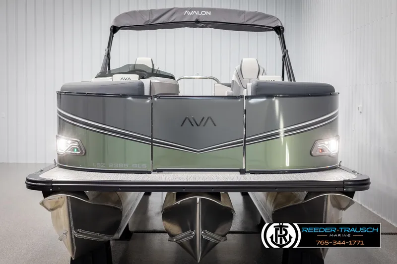 Slide: The Image of 2025 Avalon LSZ QLS pontoon boat, front view, in showroom setting. - 7