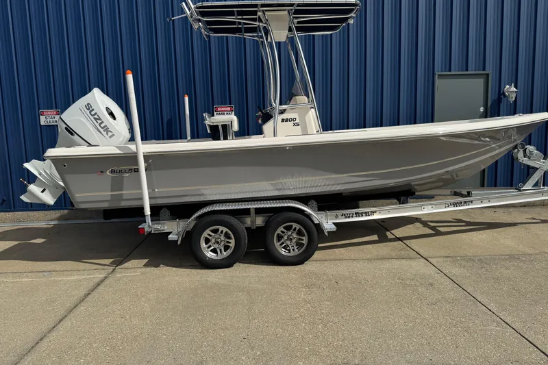 The Image of 2026 Bulls Bay 2200 boat on trailer, parked by blue building. - 0