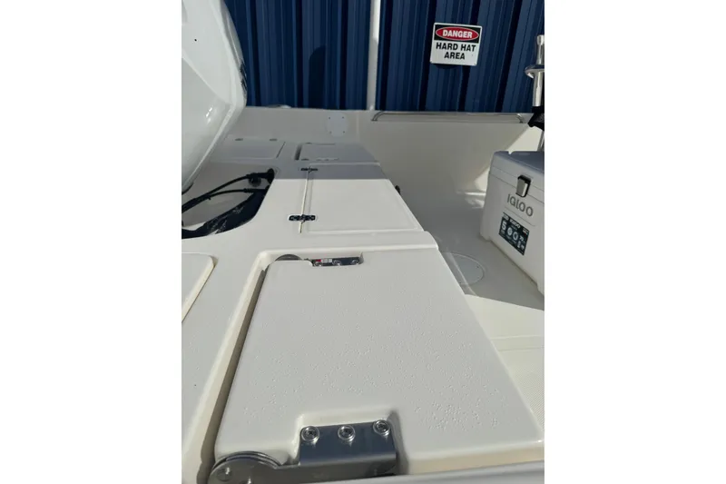 Slide: The Image of 2026 Bulls Bay 2200 boat interior with storage compartments and Igloo cooler. - 3