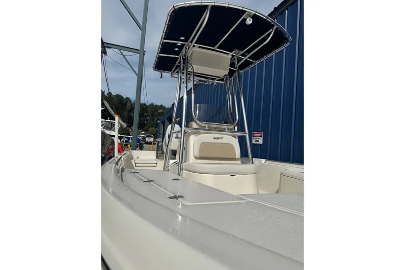 Slide: The Image of 2026 Bulls Bay 2200 boat with T-top, docked near blue building. - 9