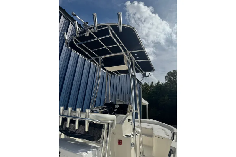 Slide: The Image of 2026 Bulls Bay 2200 XS boat on trailer, parked outdoors near trees and building. - 10