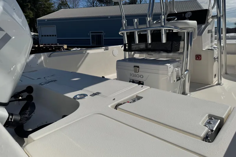 Slide: The Image of 2026 Bulls Bay 2200 XS boat interior with Igloo cooler and rod holders. - 12